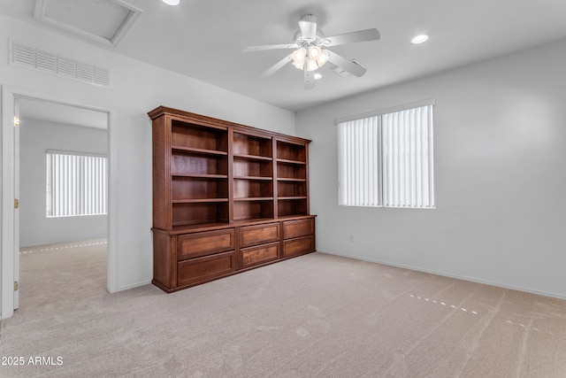 carpeted empty room with ceiling fan and a healthy amount of sunlight