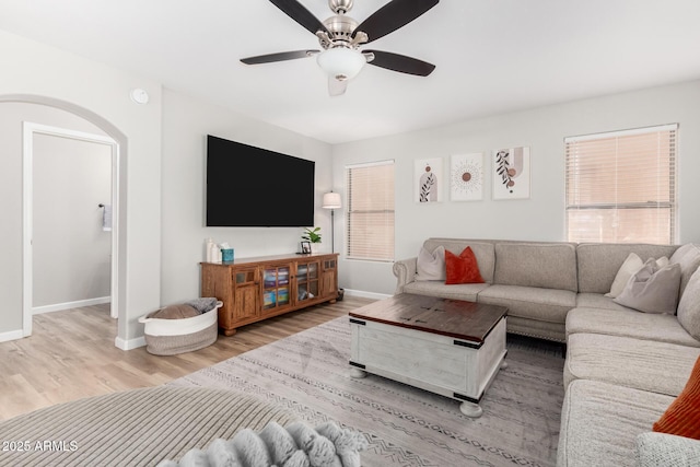 living room with ceiling fan and light wood-type flooring