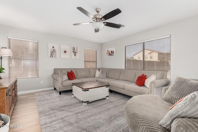 living room featuring light hardwood / wood-style floors and ceiling fan