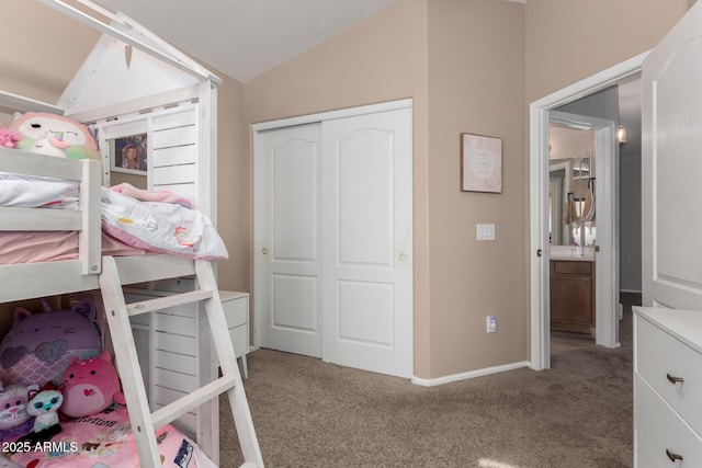 bedroom with vaulted ceiling, a closet, and carpet