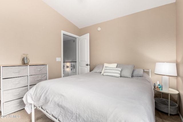 carpeted bedroom with vaulted ceiling