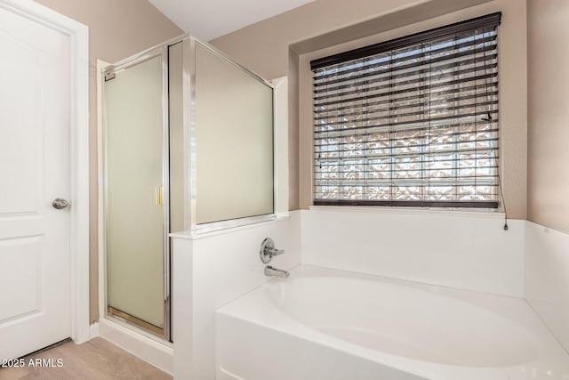 bathroom featuring independent shower and bath and wood-type flooring