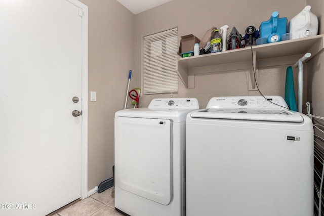 washroom with light tile patterned flooring and washer and clothes dryer