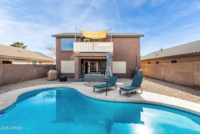 back of property featuring central AC, an outdoor hangout area, a fenced in pool, and a patio area