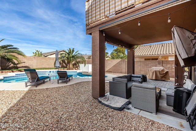 view of patio featuring area for grilling, a fenced in pool, and an outdoor hangout area