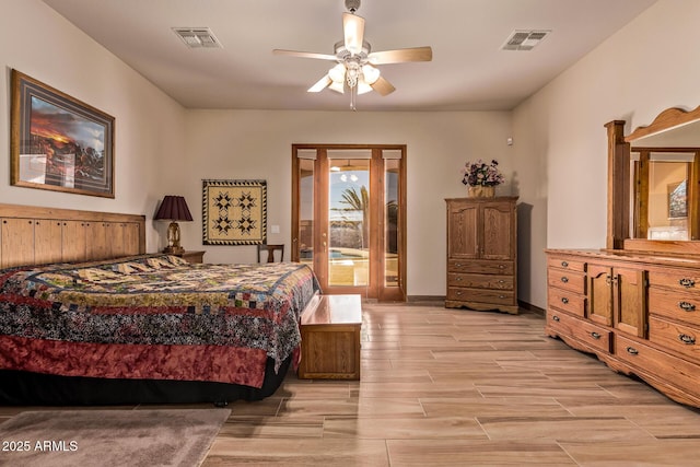 bedroom with access to exterior, wood tiled floor, visible vents, and baseboards