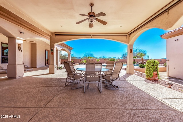 view of patio / terrace featuring outdoor dining area, fence, and ceiling fan
