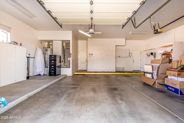 garage featuring water heater and a garage door opener