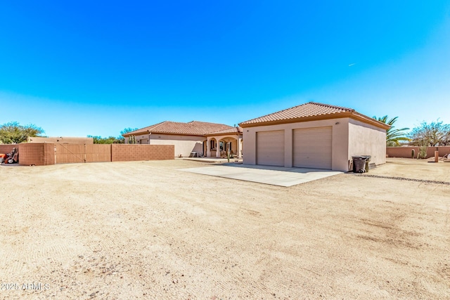exterior space featuring driveway and fence