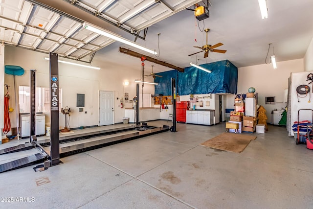 garage with electric panel, a garage door opener, and a ceiling fan
