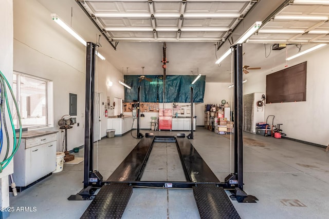 workout room featuring a ceiling fan and electric panel