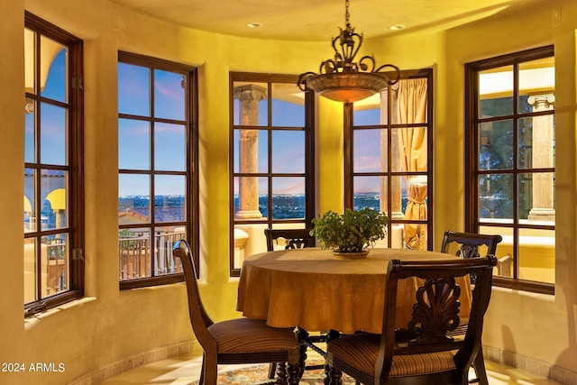 dining area featuring plenty of natural light and a notable chandelier