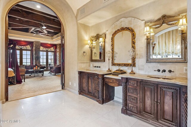 bathroom featuring a relaxing tiled tub and ornate columns