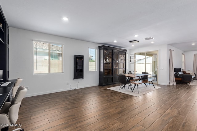 living room featuring a wealth of natural light and dark hardwood / wood-style floors