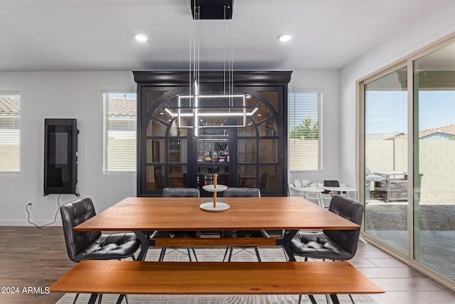 dining area with wood-type flooring and a wealth of natural light