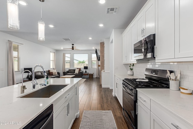 kitchen featuring ceiling fan, sink, white cabinetry, stainless steel appliances, and dark hardwood / wood-style flooring