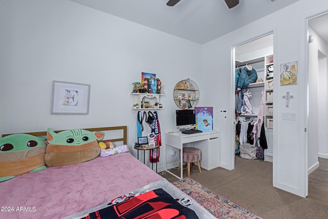 bedroom featuring dark colored carpet, ceiling fan, and a closet