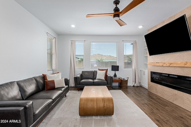 living room featuring ceiling fan and hardwood / wood-style floors