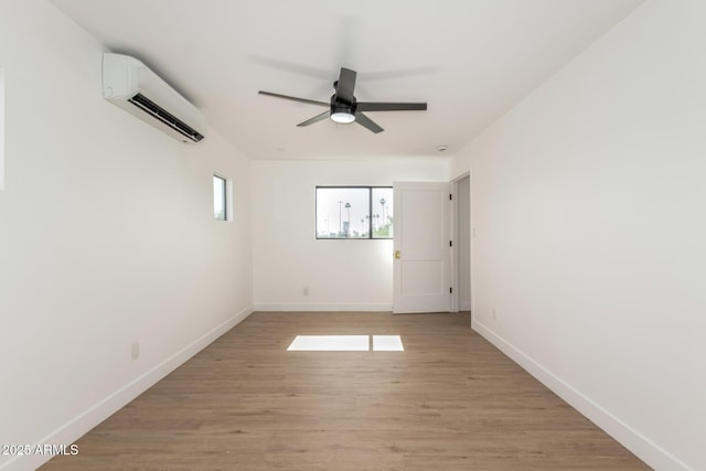 1338 E Granada Rd, Phoenix, AZ 85006 - spare room featuring an AC wall unit, a ceiling fan, and light wood-style flooring