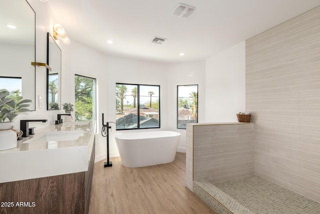 1338 E Granada Rd, Phoenix, AZ 85006 - full bathroom with wood finished floors, a freestanding bath, double vanity, and recessed lighting