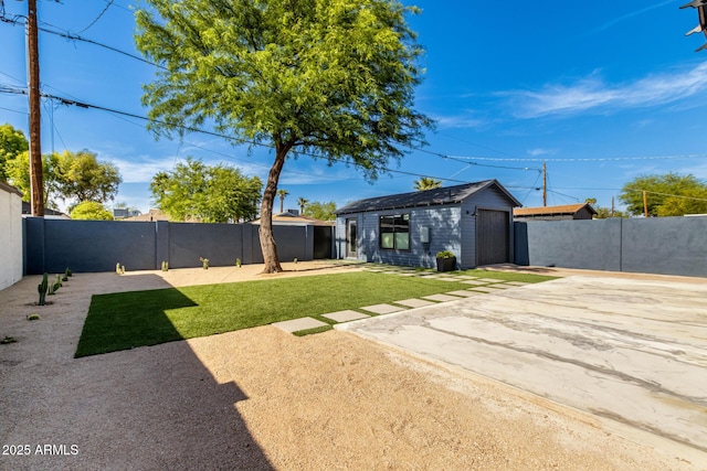 1338 E Granada Rd, Phoenix, AZ 85006 - fenced backyard with a patio, an outdoor structure, concrete driveway, and a garage
