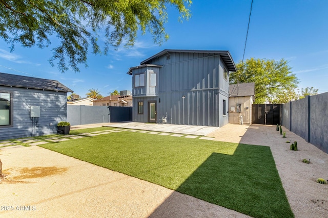 1338 E Granada Rd, Phoenix, AZ 85006 - rear view of property with board and batten siding, a fenced backyard, a patio, and a gate