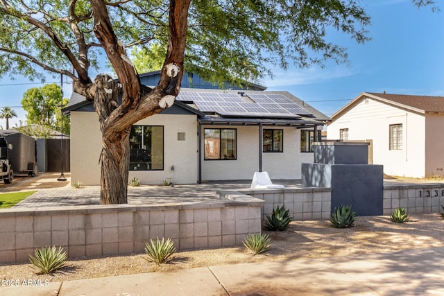 1338 E Granada Rd, Phoenix, AZ 85006 - view of front of house with roof mounted solar panels, a patio area, and stucco siding