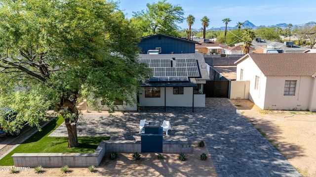 1338 E Granada Rd, Phoenix, AZ 85006 - back of property with solar panels, roof with shingles, a residential view, stucco siding, and a mountain view