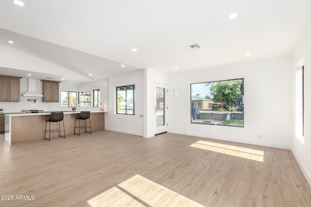 1338 E Granada Rd, Phoenix, AZ 85006 - unfurnished living room with light wood finished floors, recessed lighting, and lofted ceiling