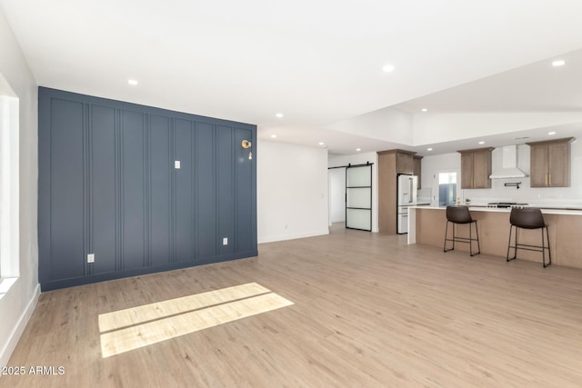 1338 E Granada Rd, Phoenix, AZ 85006 - living area with a barn door, light wood finished floors, and recessed lighting