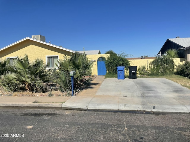 view of front of home with stucco siding and cooling unit