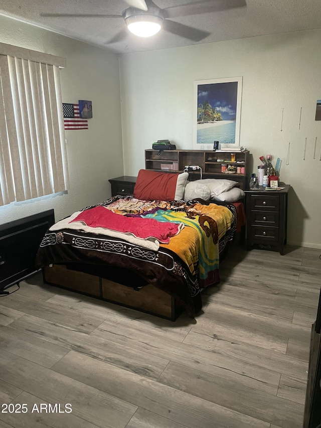bedroom with ceiling fan and wood finished floors