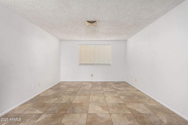 unfurnished room featuring a textured ceiling