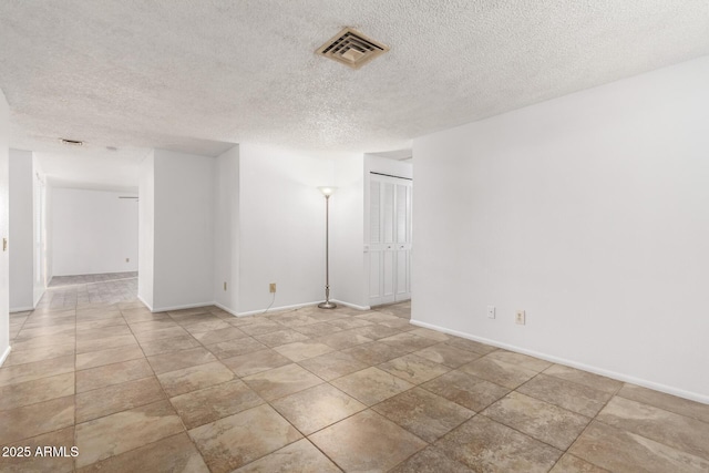 unfurnished room featuring a textured ceiling