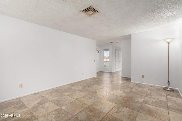 spare room featuring a textured ceiling