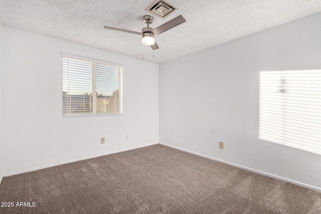 carpeted spare room with ceiling fan and a textured ceiling