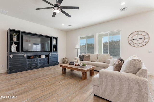 living room with ceiling fan and light wood-type flooring