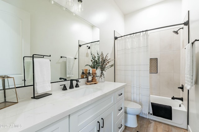 full bathroom with vanity, hardwood / wood-style floors, shower / tub combo, and toilet