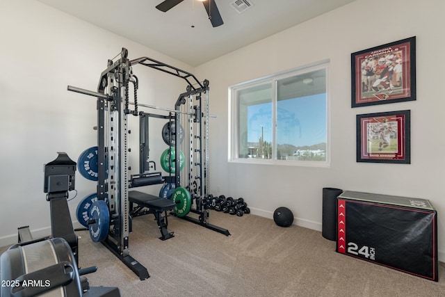 exercise room with light carpet and ceiling fan