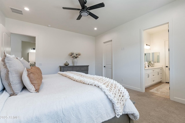 carpeted bedroom featuring ensuite bathroom and ceiling fan