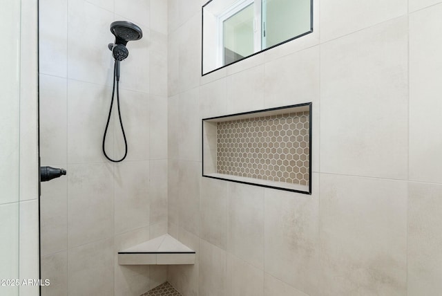 bathroom with a tile shower