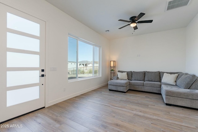 living room with ceiling fan and light hardwood / wood-style flooring