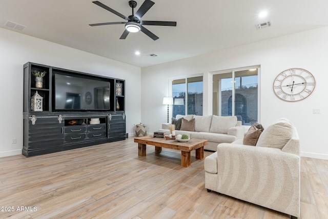 living room featuring ceiling fan and light hardwood / wood-style floors