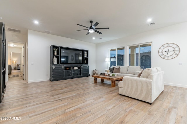 living room featuring light hardwood / wood-style floors and ceiling fan