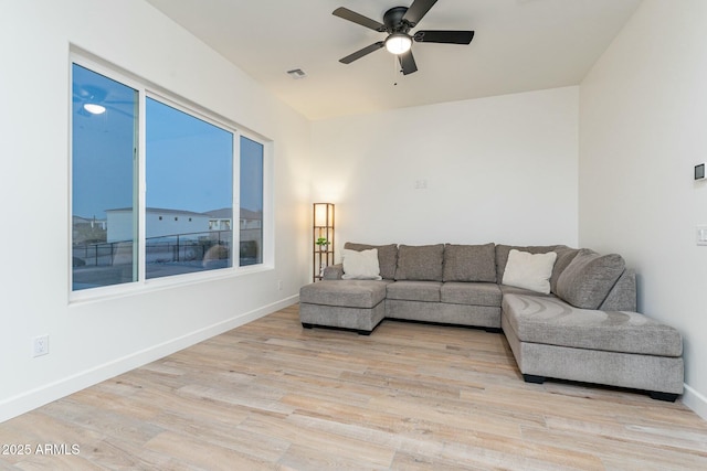 living room with light hardwood / wood-style flooring and ceiling fan