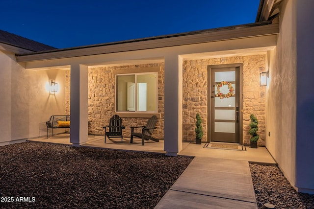 view of exterior entry at twilight