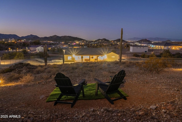 back house at dusk featuring a mountain view