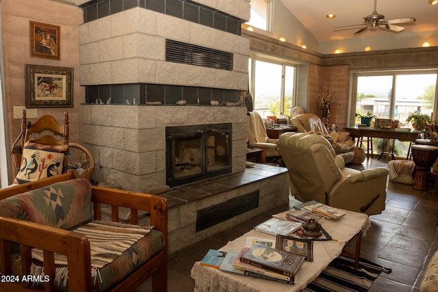 living room featuring vaulted ceiling, recessed lighting, a fireplace, and ceiling fan