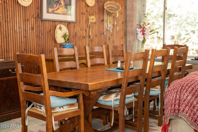 dining room with wood walls