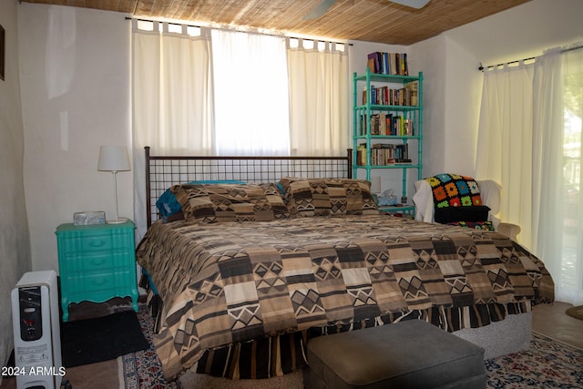 bedroom featuring heating unit and wooden ceiling